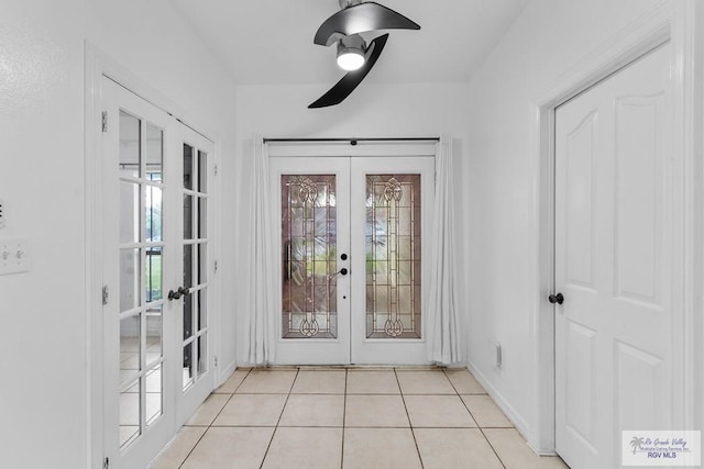 doorway with light tile patterned floors and french doors