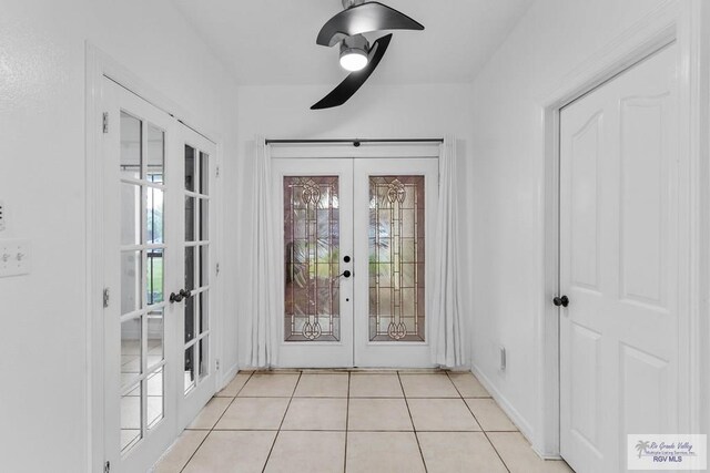 doorway with light tile patterned floors and french doors