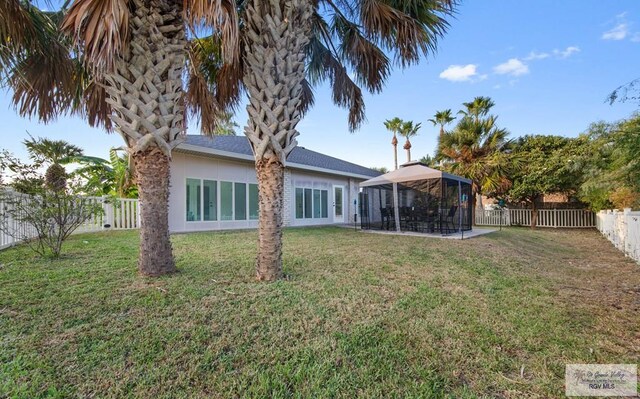 rear view of house with a yard