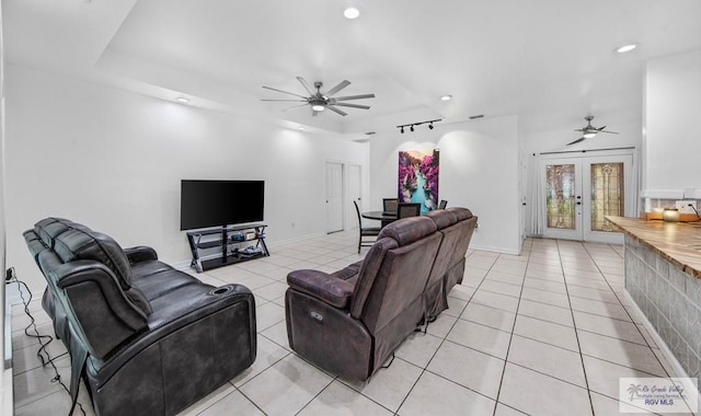 tiled living room featuring french doors and ceiling fan