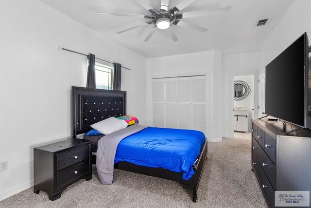 carpeted bedroom with ceiling fan and a closet