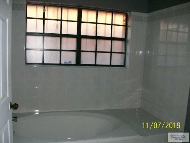 bathroom with a washtub