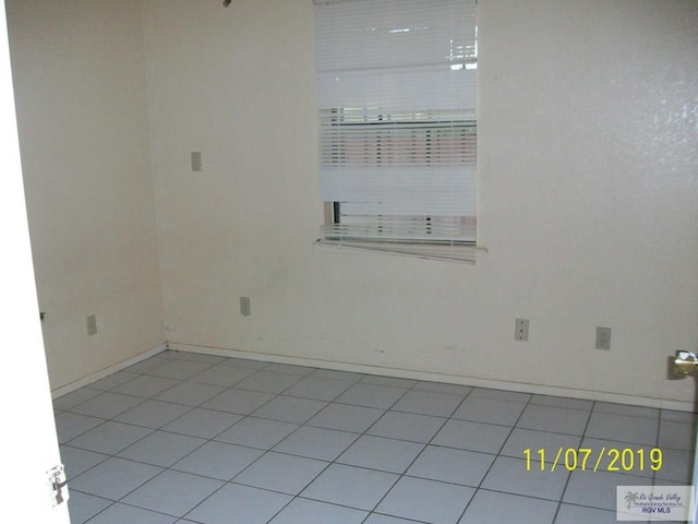 unfurnished room with light tile patterned floors