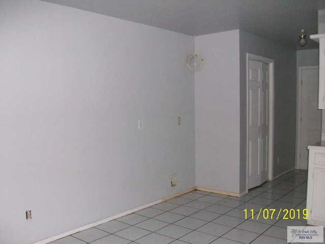 unfurnished room featuring light tile patterned flooring