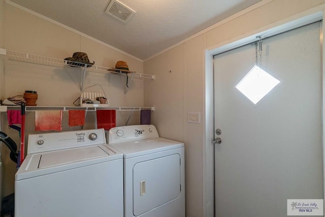 washroom with washing machine and dryer and ornamental molding