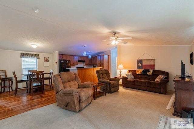 living room with ceiling fan, carpet, and lofted ceiling