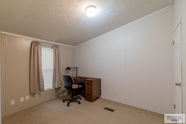 carpeted home office with a textured ceiling and ornamental molding