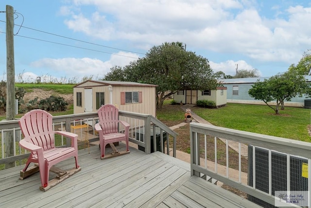 wooden deck with a yard and a storage shed