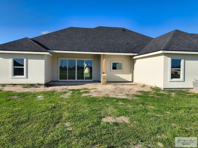 9728 Heights S Unit 9, Harlingen, TX 78552 - rear view of property featuring a shingled roof, stucco siding, and a yard