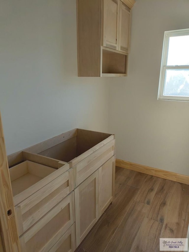 9728 Heights S Unit 9, Harlingen, TX 78552 - laundry area with dark wood-style floors and baseboards