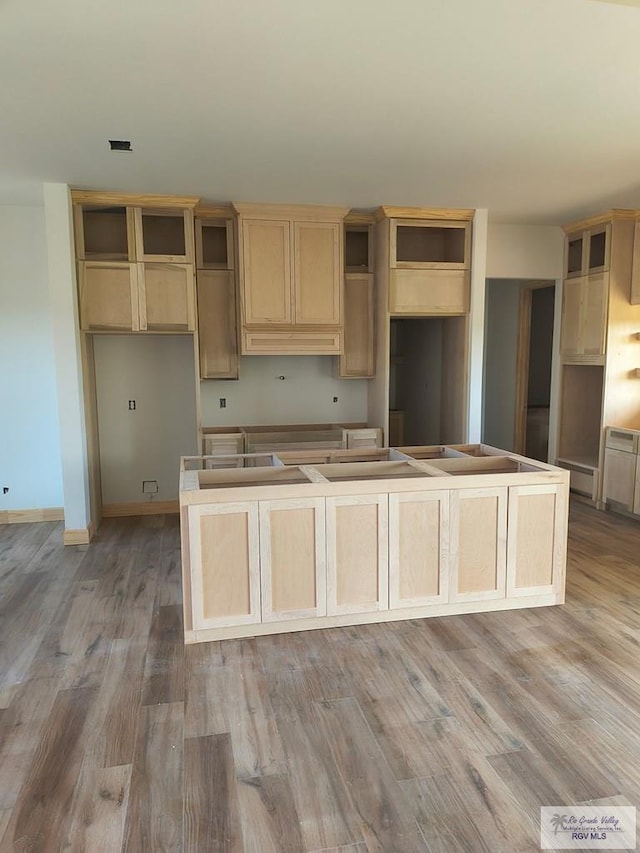 9728 Heights S Unit 9, Harlingen, TX 78552 - kitchen featuring wood finished floors, a kitchen island, and a baseboard radiator