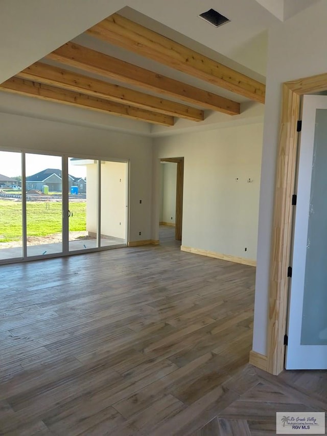9728 Heights S Unit 9, Harlingen, TX 78552 - empty room featuring beamed ceiling and wood finished floors