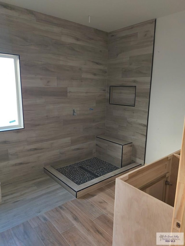 9728 Heights S Unit 9, Harlingen, TX 78552 - bathroom with a sauna / steam room, tiled shower, and wood finished floors
