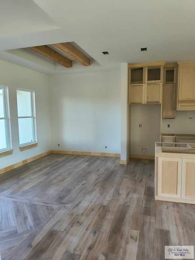 9728 Heights S Unit 9, Harlingen, TX 78552 - kitchen with beam ceiling, light wood-style floors, and light brown cabinetry
