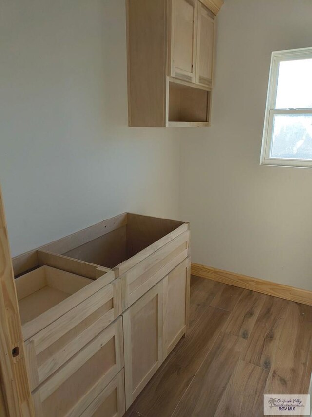9728 Heights S Unit 9, Harlingen, TX 78552 - laundry area with dark wood-style floors and baseboards