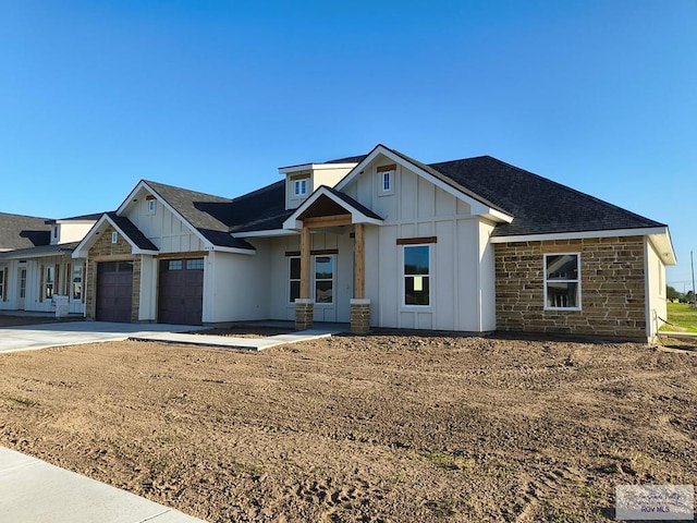 9728 Heights S Unit 9, Harlingen, TX 78552 - modern farmhouse style home with board and batten siding, a garage, concrete driveway, and stone siding