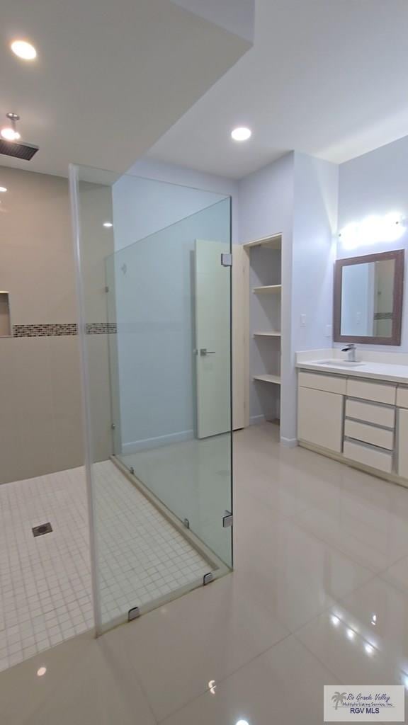 full bathroom with a walk in shower, tile patterned floors, recessed lighting, and vanity
