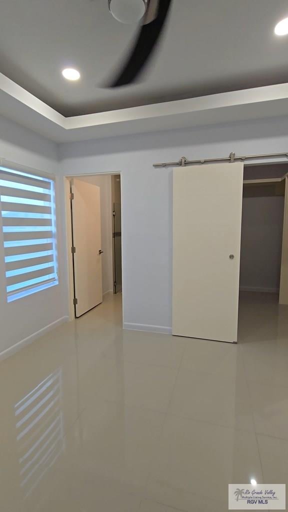 unfurnished room with light tile patterned floors, baseboards, and recessed lighting