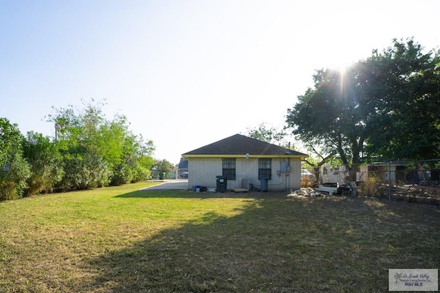 back of house featuring a lawn and fence