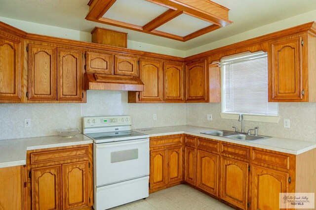 kitchen with premium range hood, a sink, white electric stove, brown cabinetry, and light countertops