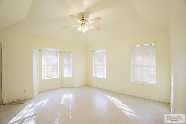 spare room featuring baseboards and ceiling fan