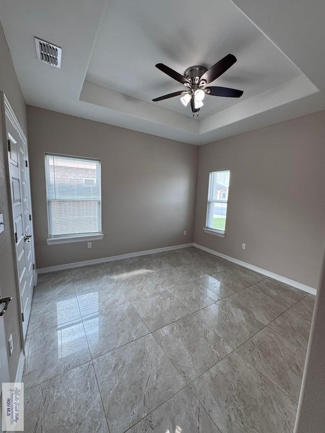 4805 N Westgate Cir, Harlingen, TX 78552 - unfurnished room with a raised ceiling, ceiling fan, and baseboards
