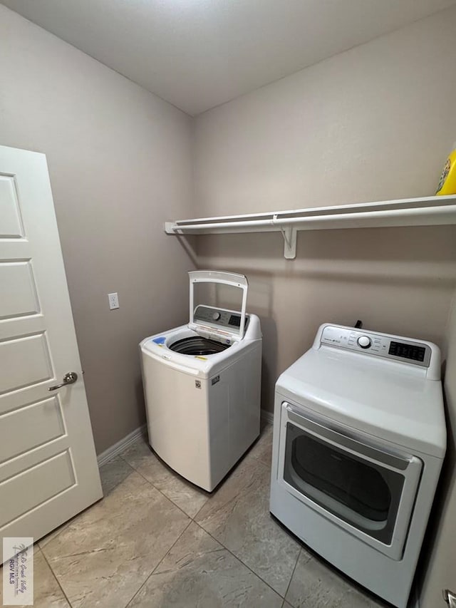 4805 N Westgate Cir, Harlingen, TX 78552 - washroom featuring washer and clothes dryer and baseboards