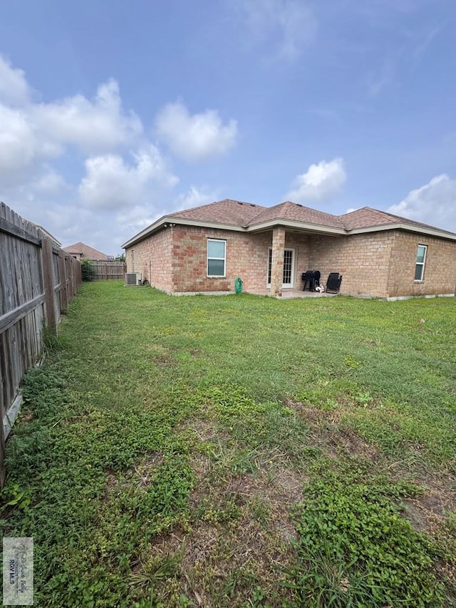 4805 N Westgate Cir, Harlingen, TX 78552 - rear view of property featuring brick siding and cooling unit