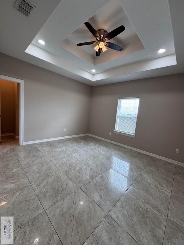 4805 N Westgate Cir, Harlingen, TX 78552 - empty room featuring a raised ceiling, a ceiling fan, marble look tiles, baseboards, and recessed lighting