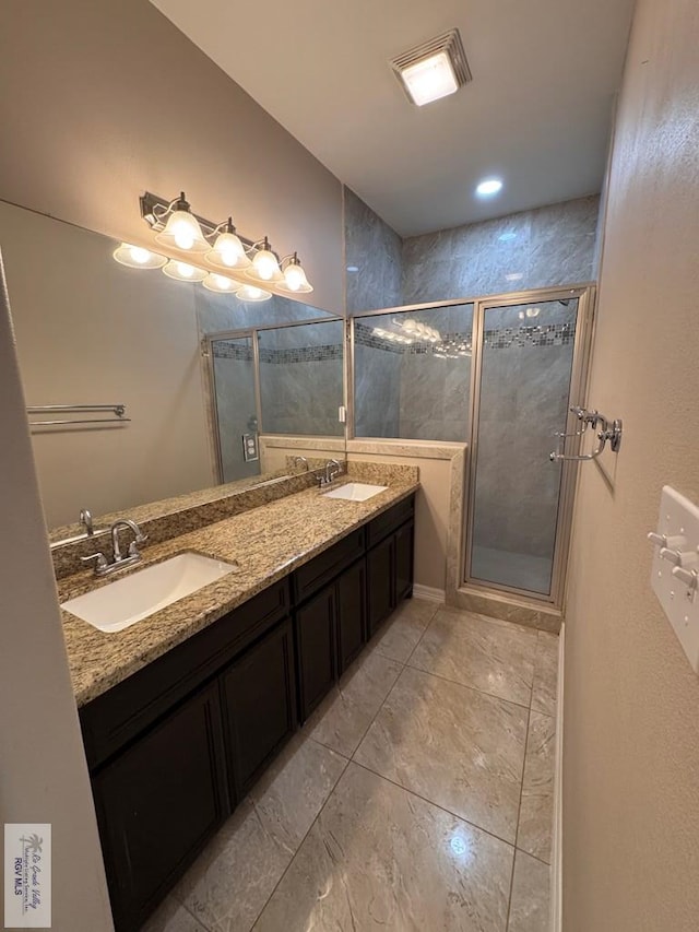 4805 N Westgate Cir, Harlingen, TX 78552 - bathroom featuring double vanity, a stall shower, and marble finish flooring