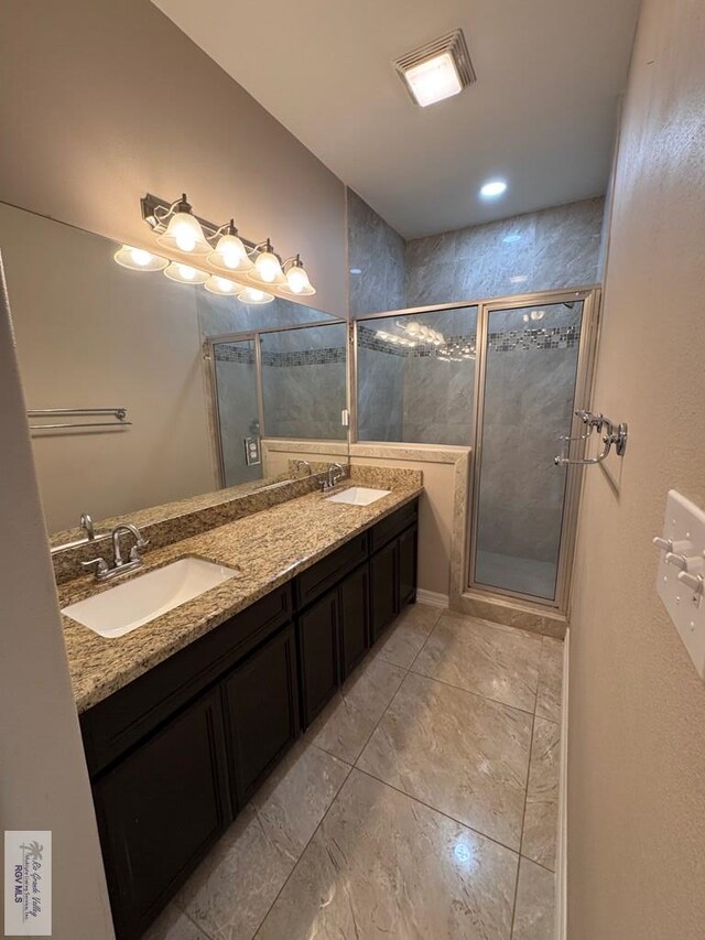 4805 N Westgate Cir, Harlingen, TX 78552 - bathroom featuring double vanity, a stall shower, and marble finish flooring