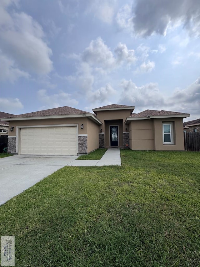 4805 N Westgate Cir, Harlingen, TX 78552 - prairie-style home with stucco siding, driveway, a garage, and stone siding