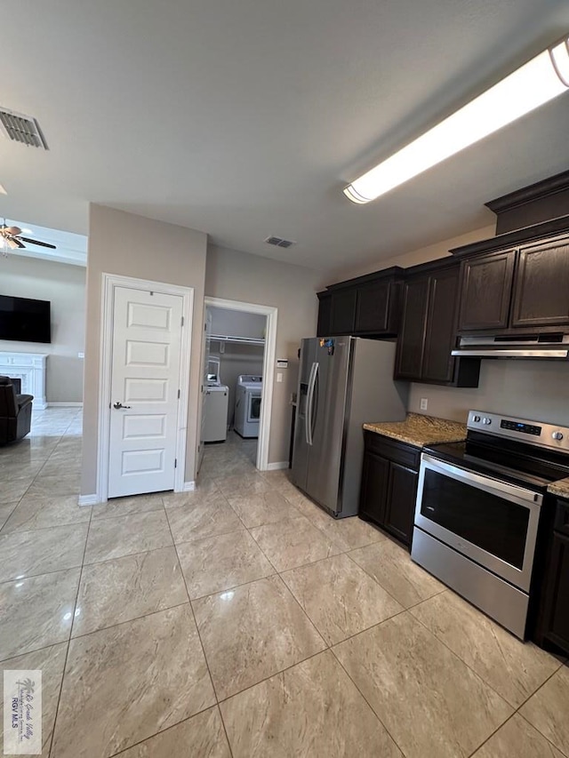 4805 N Westgate Cir, Harlingen, TX 78552 - kitchen with appliances with stainless steel finishes, separate washer and dryer, under cabinet range hood, open floor plan, and baseboards