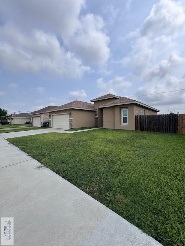 4805 N Westgate Cir, Harlingen, TX 78552 - view of front facade with stucco siding, driveway, and an attached garage