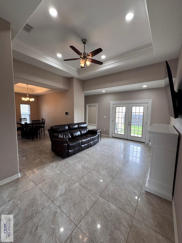 4805 N Westgate Cir, Harlingen, TX 78552 - living area featuring a tray ceiling, a chandelier, marble look tile flooring, ceiling fan, and baseboards