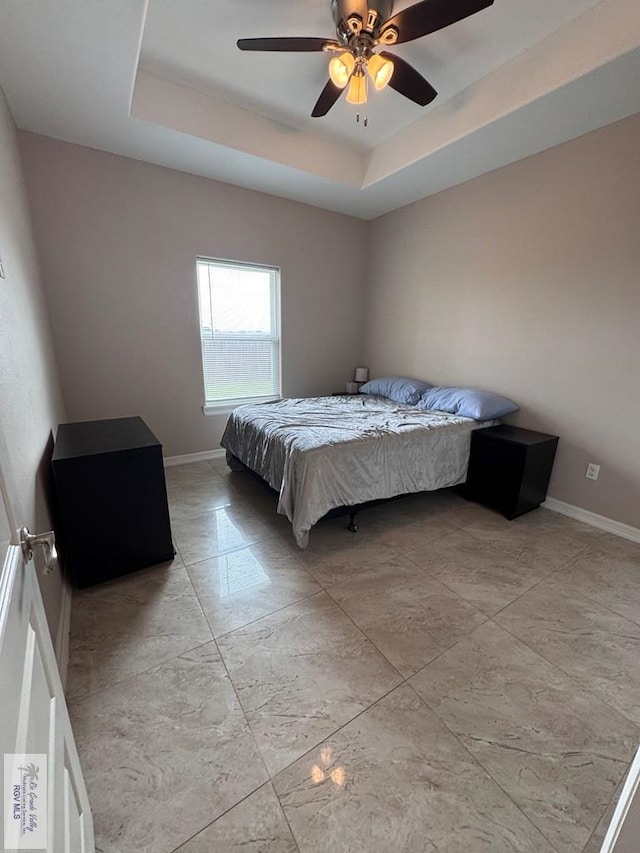 4805 N Westgate Cir, Harlingen, TX 78552 - bedroom featuring baseboards, a raised ceiling, and ceiling fan