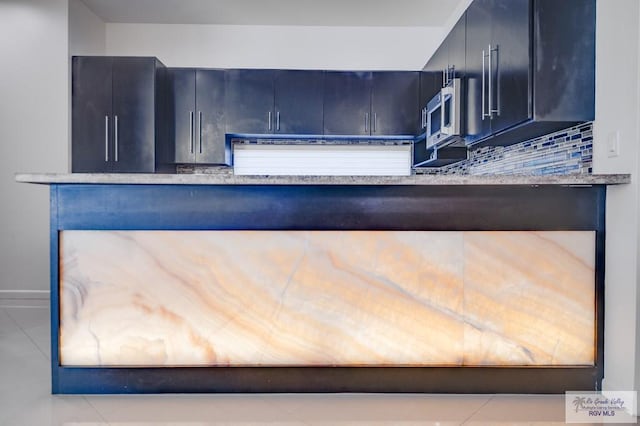 kitchen with light tile patterned floors and backsplash