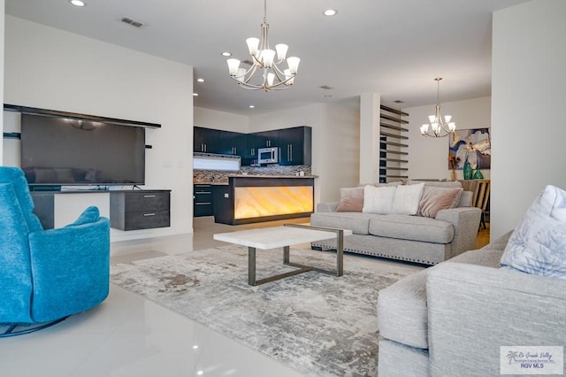 tiled living room featuring a notable chandelier