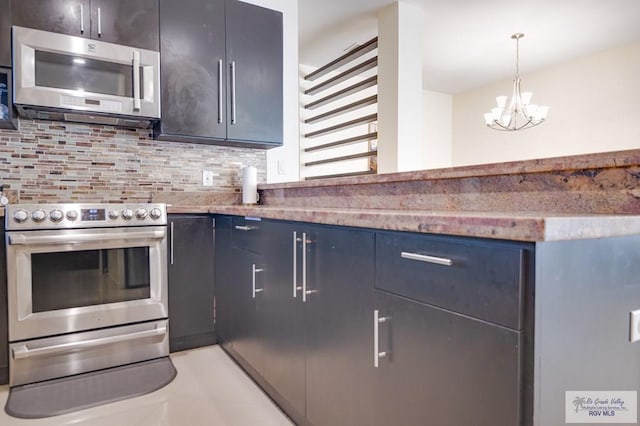 kitchen with stone countertops, hanging light fixtures, decorative backsplash, a notable chandelier, and stainless steel appliances