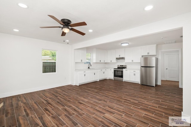 kitchen with ceiling fan, white cabinets, dark wood-type flooring, and appliances with stainless steel finishes