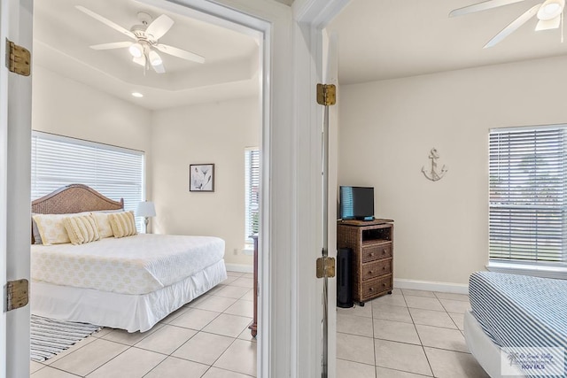 bedroom with ceiling fan and light tile patterned flooring