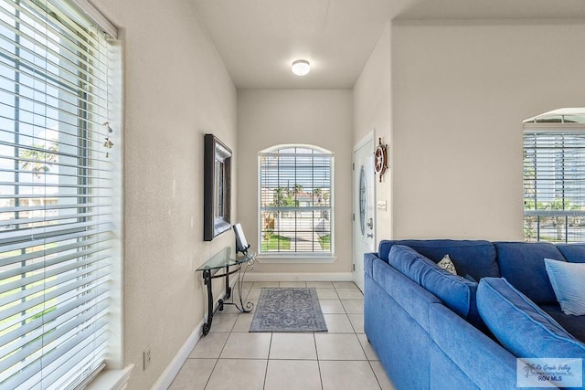 living room featuring light tile patterned flooring and a healthy amount of sunlight