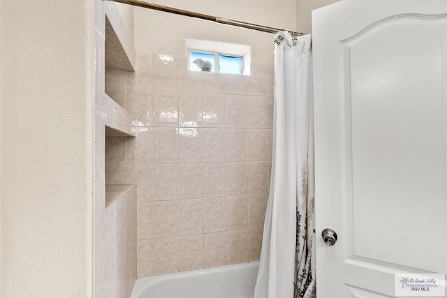 bathroom featuring shower / bathtub combination with curtain