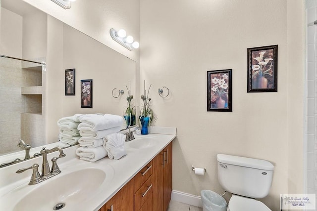 bathroom featuring tile patterned flooring, vanity, and toilet