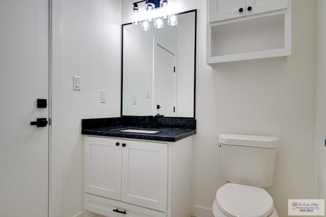 bathroom with toilet and vanity