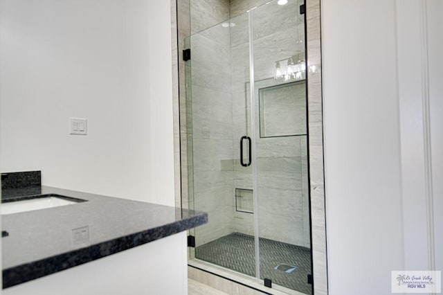 bathroom featuring vanity and a shower stall