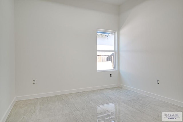 unfurnished room featuring baseboards