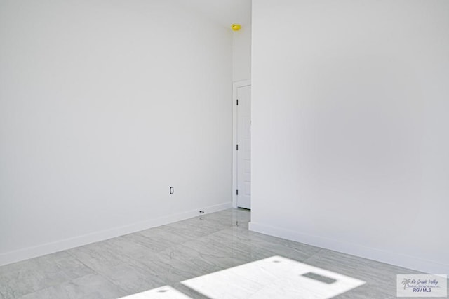 spare room with baseboards