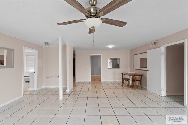 unfurnished living room with light tile patterned floors and ceiling fan