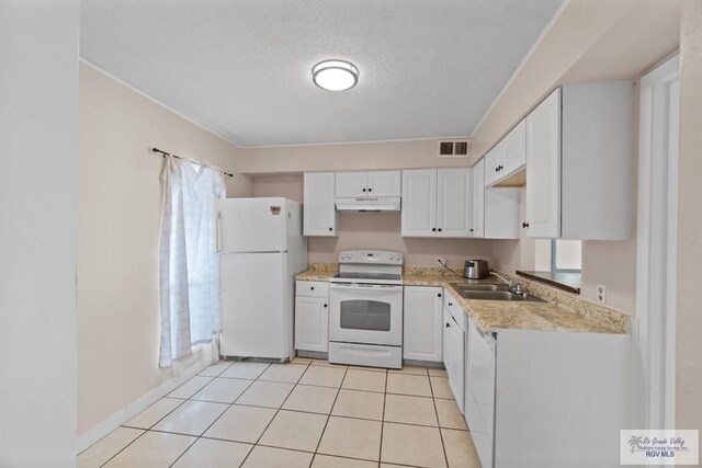 kitchen featuring a textured ceiling, white appliances, sink, white cabinets, and light tile patterned flooring